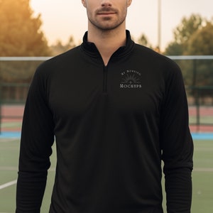 May include: A black mock neck shirt with long sleeves and a zipper. The shirt has a small embroidered design on the chest that says "My Morning Mockup".