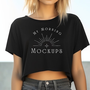 May include: A black cropped t-shirt with short sleeves and the text "MY MORNING MOCKUPS" in white. The shirt features a stylized sun graphic.