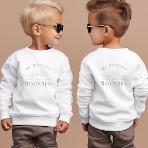May include: Two children wearing white sweatshirts with the text "My Morning Mockups" on the front and back. They are both wearing sunglasses and looking at each other.
