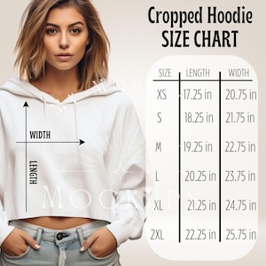 May include: A white cropped hoodie with a size chart. The chart displays measurements for sizes XS to 2XL, with lengths ranging from 17.25 inches to 22.25 inches and widths from 20.75 inches to 25.75 inches.