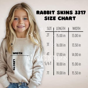 May include: A young girl wearing a beige sweatshirt, with a size chart for Rabbit Skins 3317 apparel. The chart lists sizes 2T to 7T, with length and width measurements in inches.