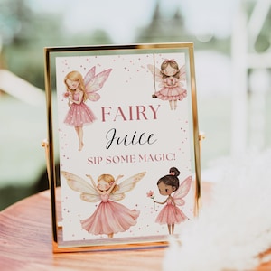 May include: A framed sign with a gold border features illustrations of fairies and the words "Fairy Juice" and "Sip Some Magic!" in pink and black script. The fairies are depicted in pink dresses with wings.