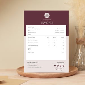 May include: A burgundy and white invoice with the text "INVOICE" at the top. The invoice includes a description of items, quantity, price, and total. The invoice also includes payment details and contact information.