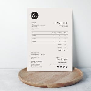 May include: Black and white invoice template with the text "Invoice" and "Thank you" in a handwritten font. The invoice includes a business name, address, website, email, and phone number. The invoice also includes a payment information section with bank name, account number, and payment date.