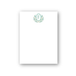 May include: White stationery with a teal and cream floral design and the letter "F" in an oval. The design is centered at the top of the page. The paper has a slight shadow.