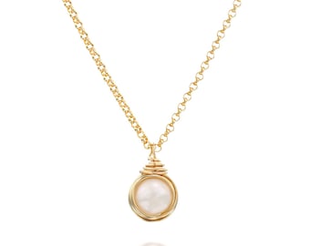 May include: A gold-colored necklace with a round, off-white pearl pendant. The pendant is encased in a spiral wire design. The chain is a delicate link style, and the necklace is displayed against a white background.