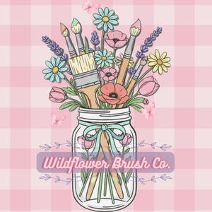 May include: A glass mason jar filled with paintbrushes and colorful wildflowers including daisies, poppies, and lavender. A light blue ribbon is tied around the jar neck. The text Wildflower Brush Co. is centered over the jar on a pink gingham background.