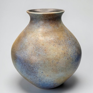 May include: A rounded ceramic vase with a wide body and a narrow neck. The surface features a mottled, textured finish with blended tones of metallic gold, bronze, and deep blue, creating a variegated appearance across the entire exterior.