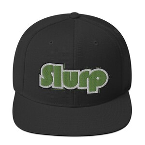 May include: A black and green embroidered baseball cap with the word "SLURP" in a retro font.