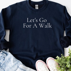 May include: A navy blue sweatshirt with the text "Let's Go For A Walk" in white lettering.