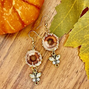 Boho beaded thread crochet earrings with butterfly dangle handmade in variegated warm colors trimmed with gold color beads