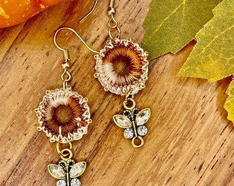 Boho crochet beaded dangle earrings made with warm variegated thread and butterfly dangle, hippie chic.