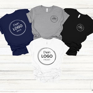 4 shirts laying on a wooden floor a navy blue shirt, a grey shirt, a black shirt and a white shirt customizable with own logo