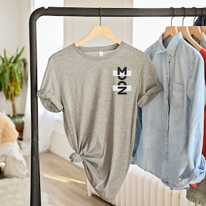 grey shirt  with pocket print on a hangeron rack