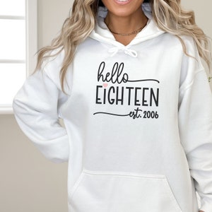 cute girl wearing oversize hoodie with hello 18 est 2006 print in front birthday gift for 18th Birthday trendy College Style