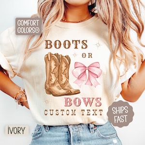 May include: Ivory-colored t-shirt with the text "Boots or Bows" and a graphic of cowboy boots and a pink bow. The shirt also has the text "Custom Text" and "Ships Fast".