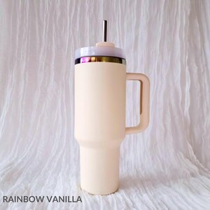 May include: A cream-colored stainless steel travel mug with a handle and a lid. The lid has a clear plastic top and a straw.