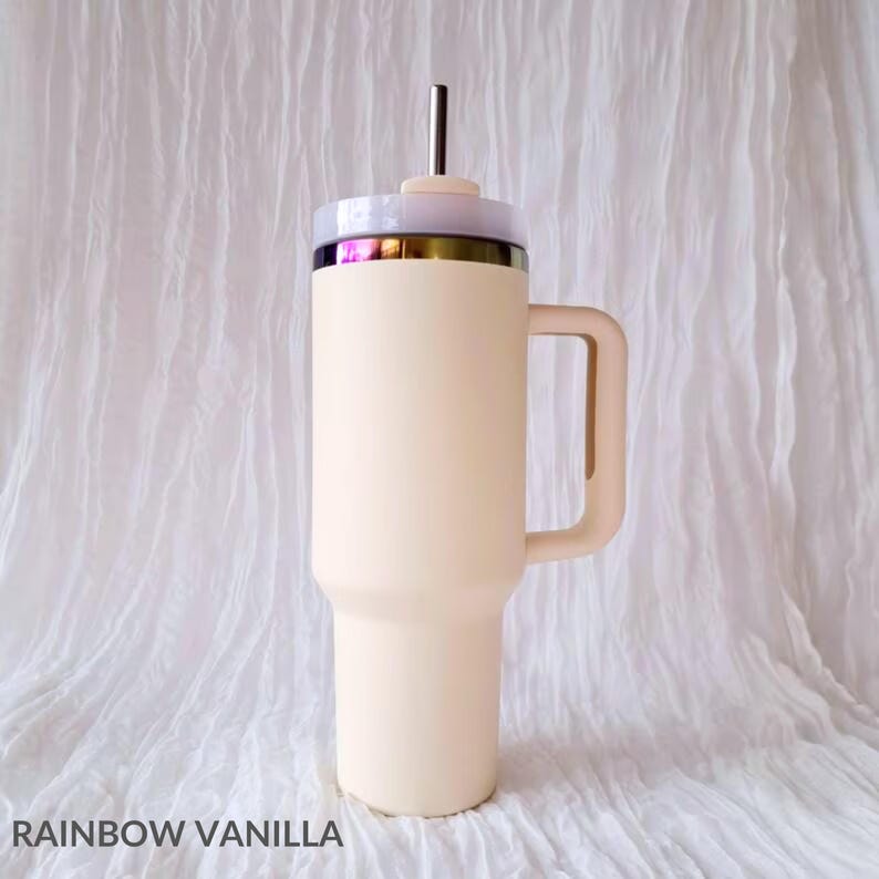 May include: A cream-colored stainless steel travel mug with a handle and a lid. The lid has a clear plastic top and a straw.