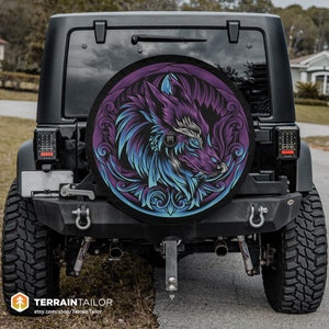 May include: A black Jeep Wrangler with a spare tire cover featuring a purple and blue wolf design. The wolf's head is surrounded by a decorative floral pattern.