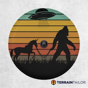 Retro Sunset Bigfoot & Unicorn Adventure: UFO-Sighting Jeep, Bronco, SUV, Camper Tire Cover - With Backup Camera Cutout