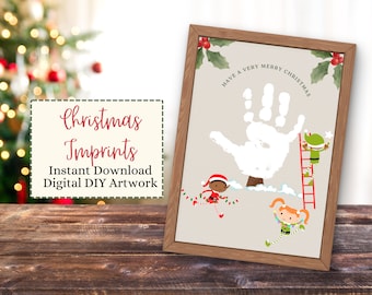 May include: A framed Christmas-themed artwork featuring a white handprint with the text "Have a Very Merry Christmas." The artwork includes illustrations of elves and the text "Christmas Imprints, Instant Download, Digital DIY Artwork."