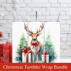 May include: A set of three Christmas-themed tumbler wraps featuring a watercolor illustration of a deer with a red bow, standing in front of two Christmas trees with presents. The background is white.