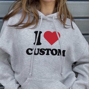 May include: Grey hooded sweatshirt with a black graphic that says "I love custom" with a red heart.