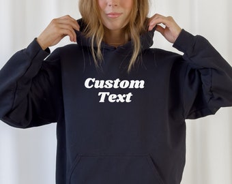 May include: A black hooded sweatshirt with a white graphic that says "Custom Text".