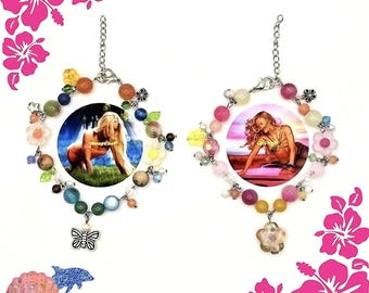 May include: Two charm bracelets featuring colorful beads, small metal charms, and central circular photo pendants. The left bracelet includes a butterfly charm and a photo labeled Midnight Sun, while the right bracelet features a flower charm and a photo.