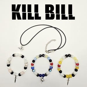 May include: Jewelry set featuring a black cord necklace with a star pendant and three beaded bracelets. The bracelets have various colored beads and charms. The text "KILL BILL" is displayed above the jewelry.