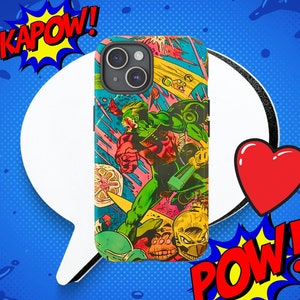 May include: A colorful phone case with a comic book style design featuring a superhero in green, red, and yellow. The case has a black camera lens and the words "KAPOW!" and "POW!" in red.