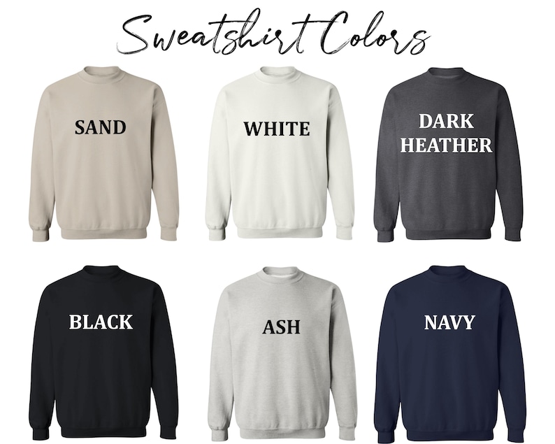 May include: Six different color sweatshirts with the color name printed in white on the front. The colors are sand, white, dark heather, black, ash, and navy.