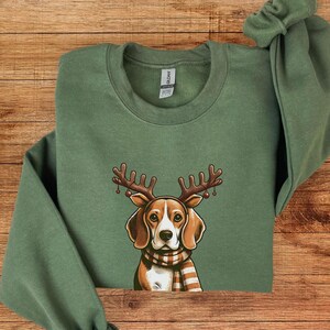 May include: Green Christmas sweatshirt with a beagle dog wearing reindeer antlers and a red and white plaid scarf.