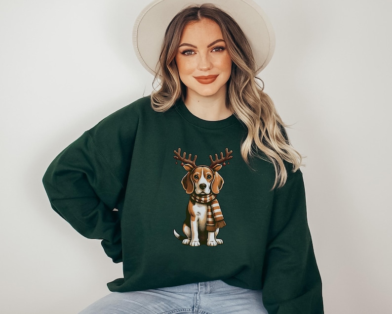 May include: A dark green sweatshirt with a cartoon image of a beagle wearing a brown and white scarf and reindeer antlers.