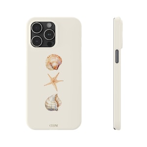 May include: A white iPhone case featuring a seashell and starfish design. The case has a camera cutout and the word "CELINE" printed on the bottom.