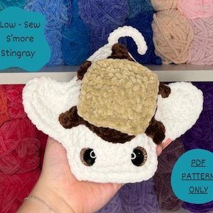 May include: A white, brown, and tan crocheted stingray plush toy with large dark eyes. The stingray features a square tan center patch resembling a s'more. Text on the image reads: Low-Sew S'more Stingray and PDF PATTERN ONLY.