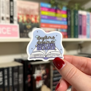 May include: A blue and white sticker with a book and the text "daytime dreamer nighttime reader" with stars and clouds.