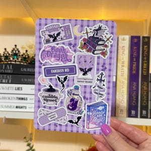 May include: A purple and white checkered sticker sheet with fantasy-themed illustrations. The sheet features stickers of dragons, books, potions, and the text "Fantasy RD" and "Books are Magic".