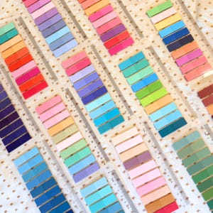 May include: Assortment of colorful sticky notes with different shades of blue, green, pink, orange, and yellow. The notes are arranged in rows on a white surface with a gold pattern.