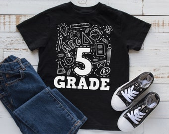 May include: Black t-shirt with a white graphic of the number 5 and the word "GRADE" surrounded by school supplies.