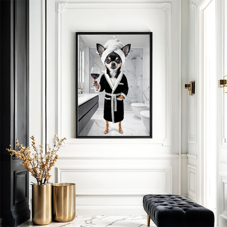 May include: A framed print featuring a Chihuahua in a black robe and a white towel on its head, holding a glass of red wine. The dog is in a bathroom setting. The robe has white trim and a white belt. The background is a modern bathroom.