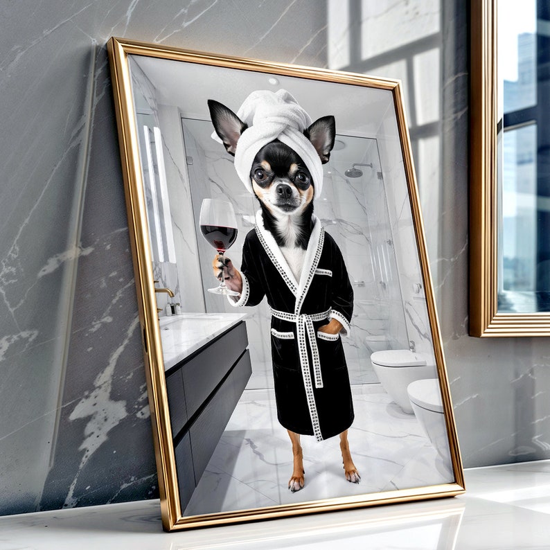May include: A framed print featuring a Chihuahua in a black robe and a white towel on its head, holding a glass of red wine. The dog is in a bathroom setting, with a mirror and a gold frame.