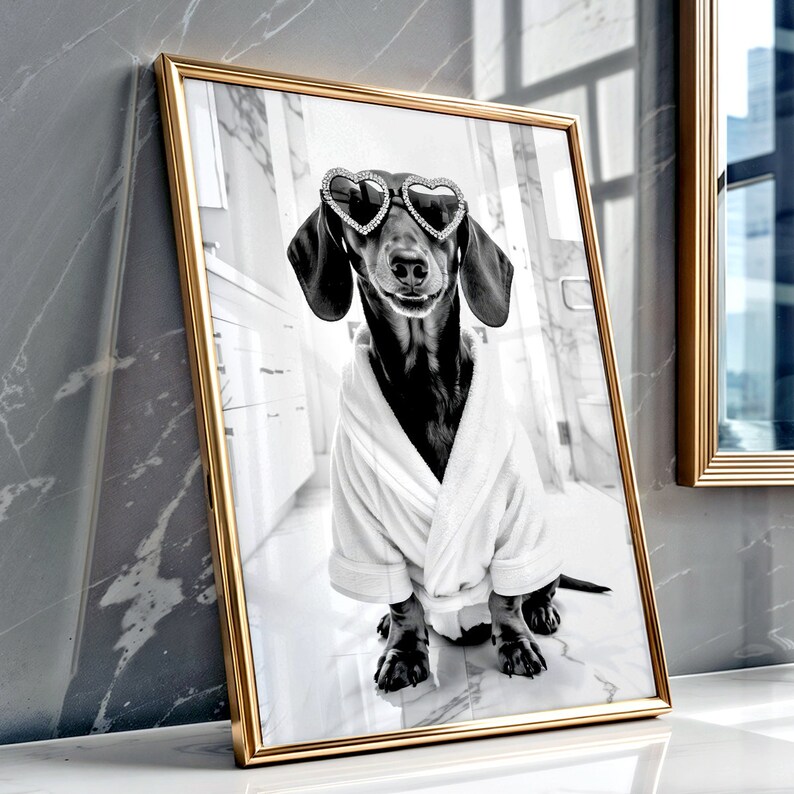 May include: A black and white photo of a dachshund wearing heart-shaped sunglasses and a white bathrobe. The dog is sitting on a white tiled floor.