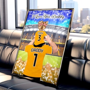 May include: A digital illustration of a father and child wearing matching soccer jerseys. The father's jersey says "Daddy 1" and the child's jersey says "Cody 3". The image is set against a backdrop of a stadium with a crowd of cheering fans. The text "I Love You Daddy" is written across the top of the image.