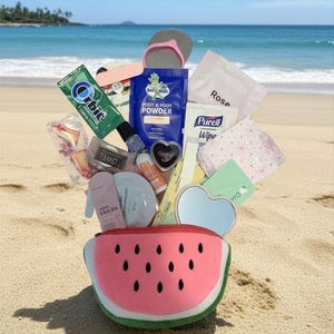 May include: A watermelon-shaped pouch filled with various travel-sized items including a green Orbit gum pack, a blue Gold Bond body and foot powder packet, a Purell wipe, a heart-shaped mirror, a pink Sakura sachet, and other assorted toiletries.