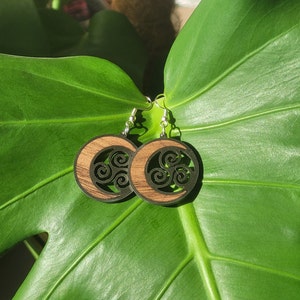 Triskel-shaped wooden and stainless steel earrings accompanied by a crescent moon, wooden jewelry