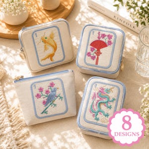 May include: Four rectangular beige fabric pouches with light blue trim and metal zippers. Each pouch features embroidered designs resembling mahjong tiles, including a yellow fish, a red fan with pink flowers, a blue bird, and a green dragon.
