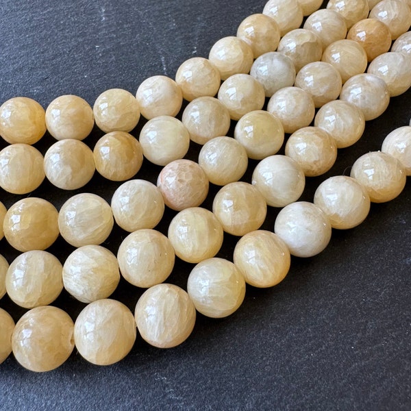 10mm yellow jade beads (undyed) - round - smooth - natural - 15" strand - approx. 35 beads