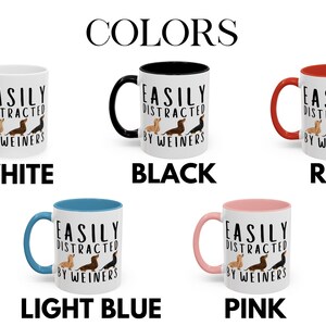 May include: Five 11-ounce ceramic mugs with different colored rims. The mugs are white with black text that reads "EASILY DISTRACTED BY WEINERS". Each mug features a line of three dachshund dogs in different colors. The mugs are displayed on a white background with the words "WHITE", "BLACK", "RED", "LIGHT BLUE", and "PINK" underneath each mug.