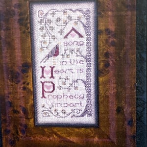 May include: A distressed wooden sign with the words "Welcome to our home" in white. The sign has a rustic finish, ideal for a porch or hallway, and features a simple, welcoming design.